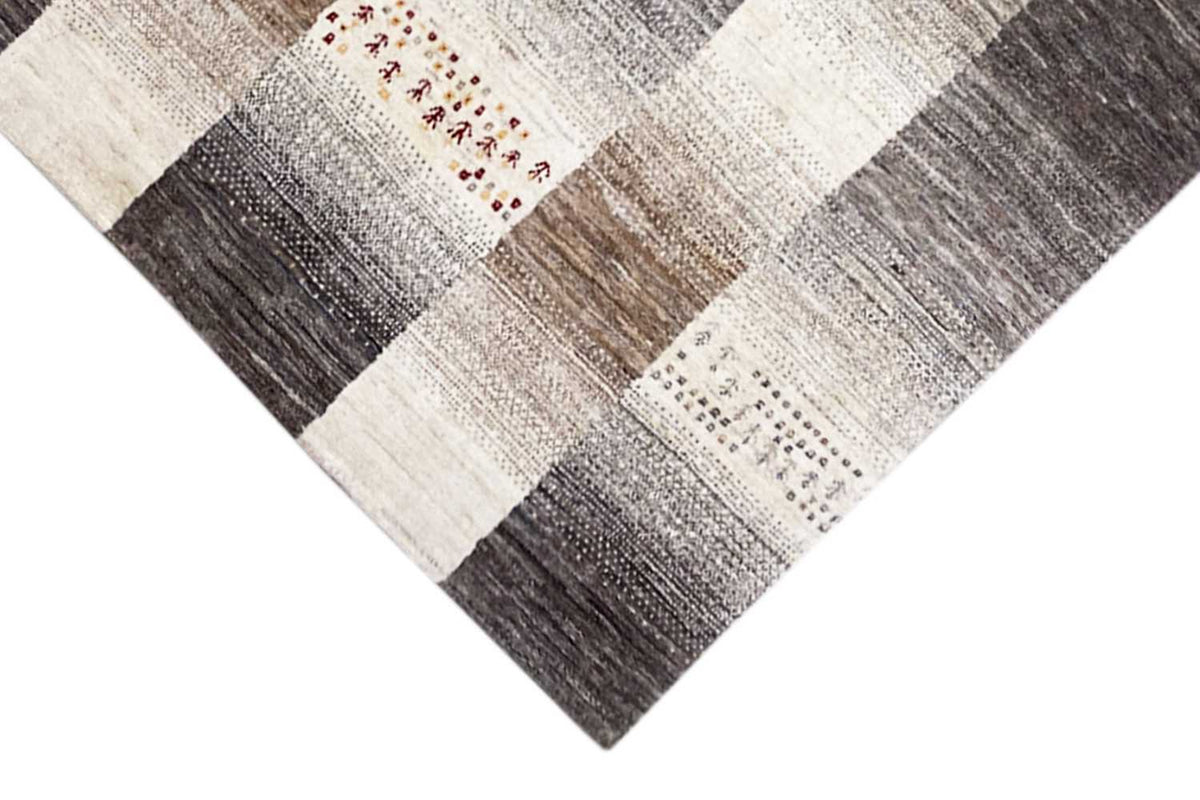 Wool rug with patchwork diamonds in light beige and dark gray, individual patterned sections