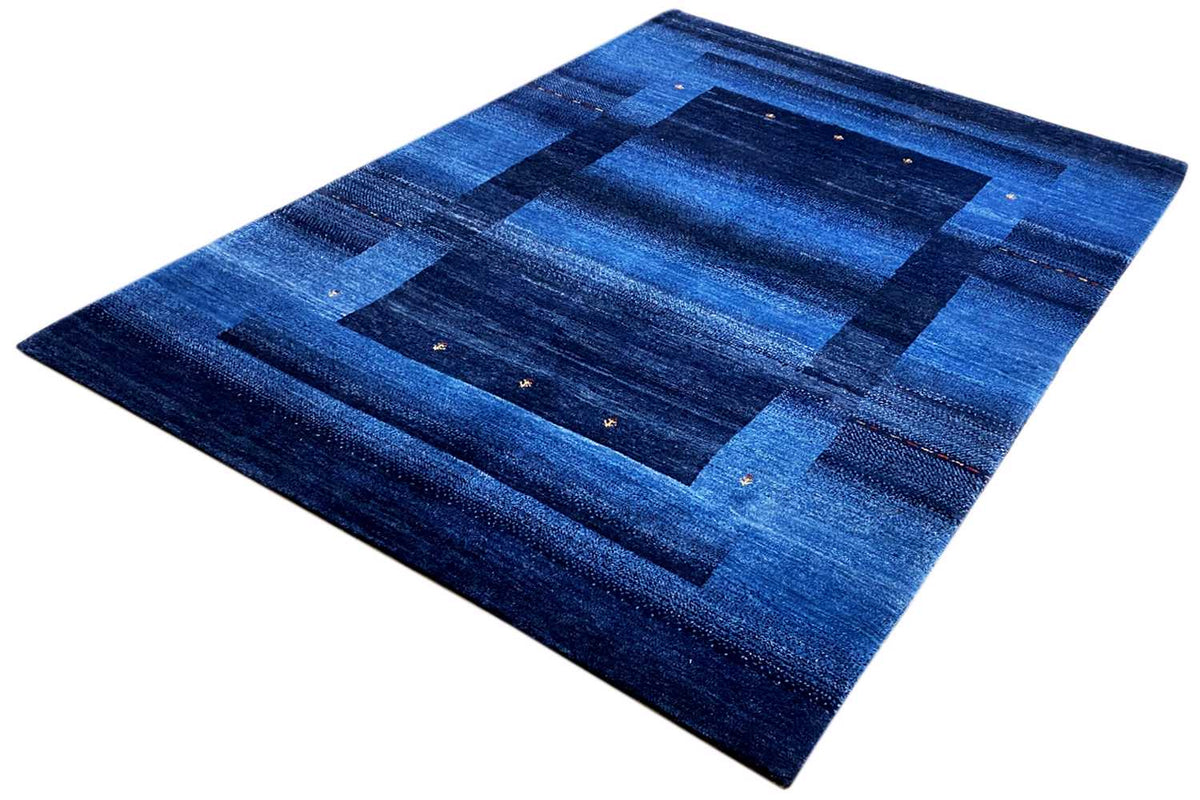 Blue Gabbeh rug 170x240 cm with a symmetrical blue design and fine speckles