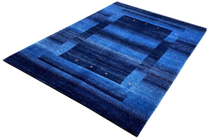 Blue Gabbeh rug 170x240 cm with a symmetrical blue design and fine speckles