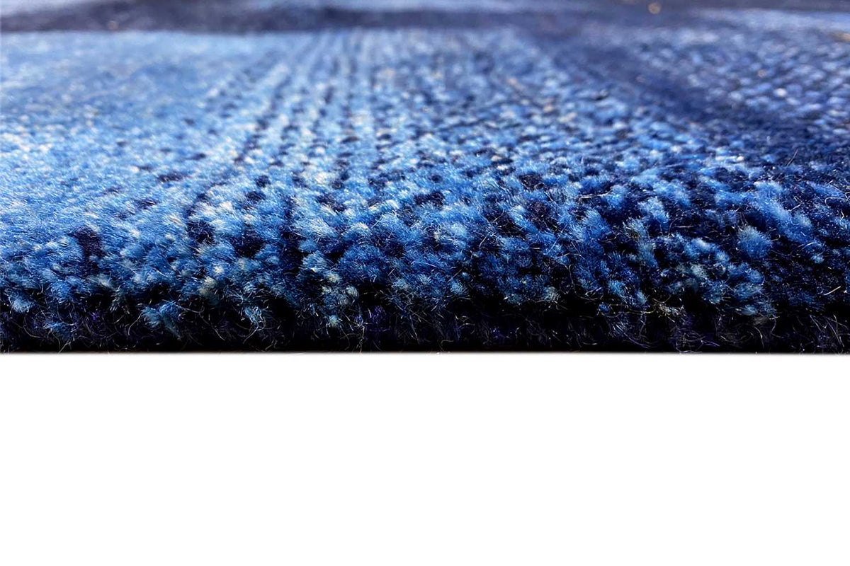 Blue Gabbeh rug: close-up of the blue mottled pile surface with fine dots