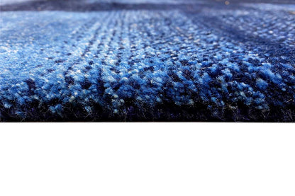 Blue Gabbeh rug: close-up of the blue mottled pile surface with fine dots