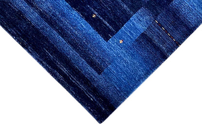 Blue Gabbeh rug, detailed view: dark and light blue stripes with small dots