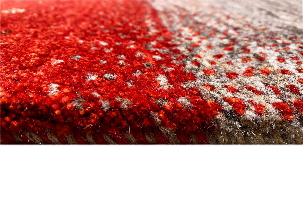 Gabbeh rug fiber texture: bold red with gray and white dotted accents
