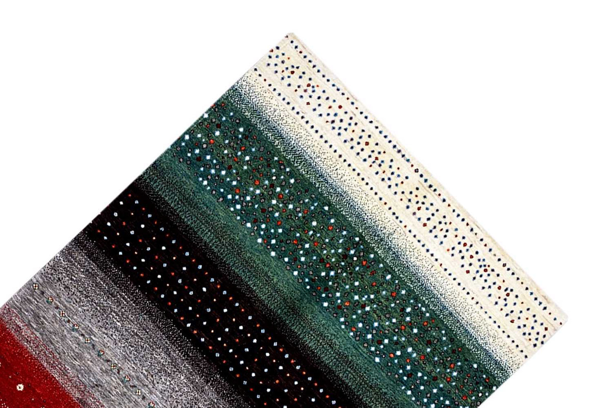 Gabbeh rug at an angle: cream-colored border with dots, stripes in petrol