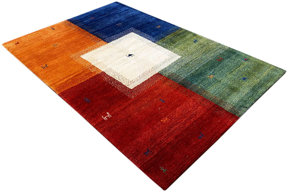 Multicolored Gabbeh rug at an angle: orange, red, blue and green color blocks