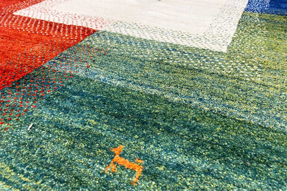 Multicolored Gabbeh rug detail: green pile with flecks of color and a light center