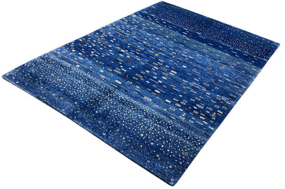Blue Gabbeh rug with geometric lines and dots, diagonal perspective