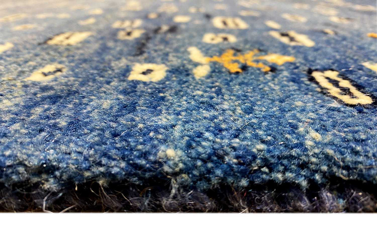 Close-up: blue carpet surface with a dense pile texture and small pattern dots