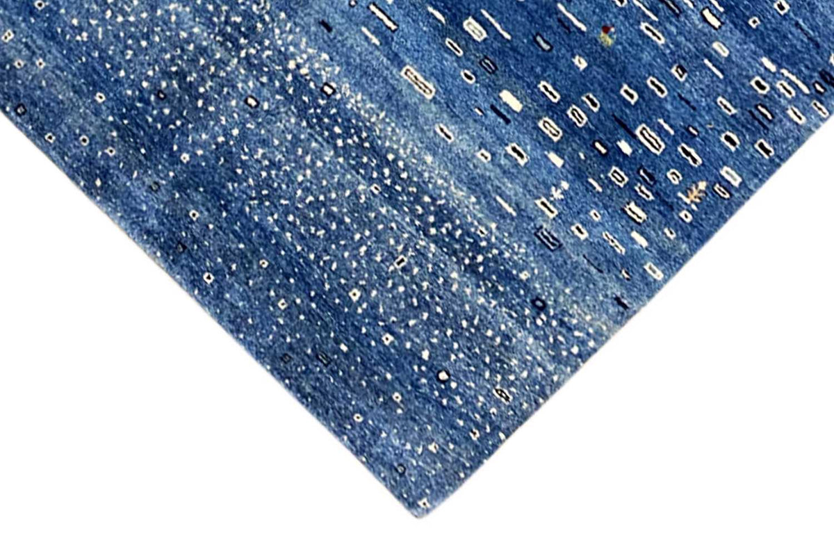 Close-up of the blue pattern: small rectangular lines and dots on the carpet