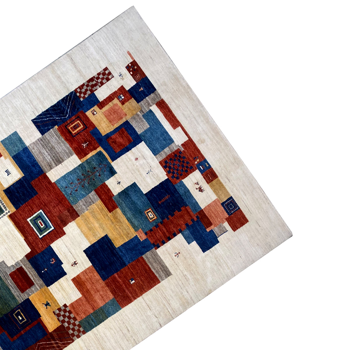 Gabbeh rug corner with a patchwork pattern in blue, red, and beige