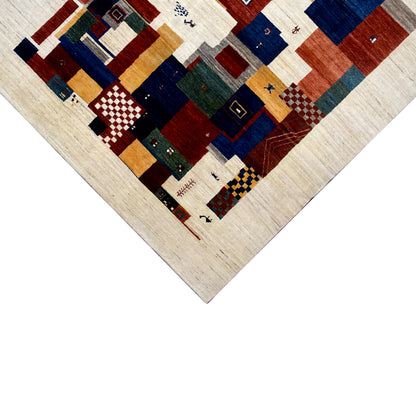 Gabbeh rug detail at the edge: geometric tiles in blue, red and beige