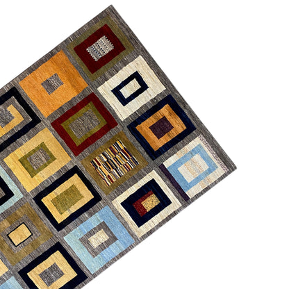 Gabbeh rug made of squares with red, green, blue, and yellow accents on gray