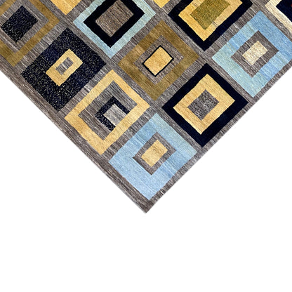 Gabbeh rug corner with a square pattern in dark blue, light blue, yellow, and gray