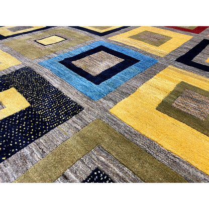 Gabbeh rug close-up: colorful diamonds and squares, textured yarn surface.