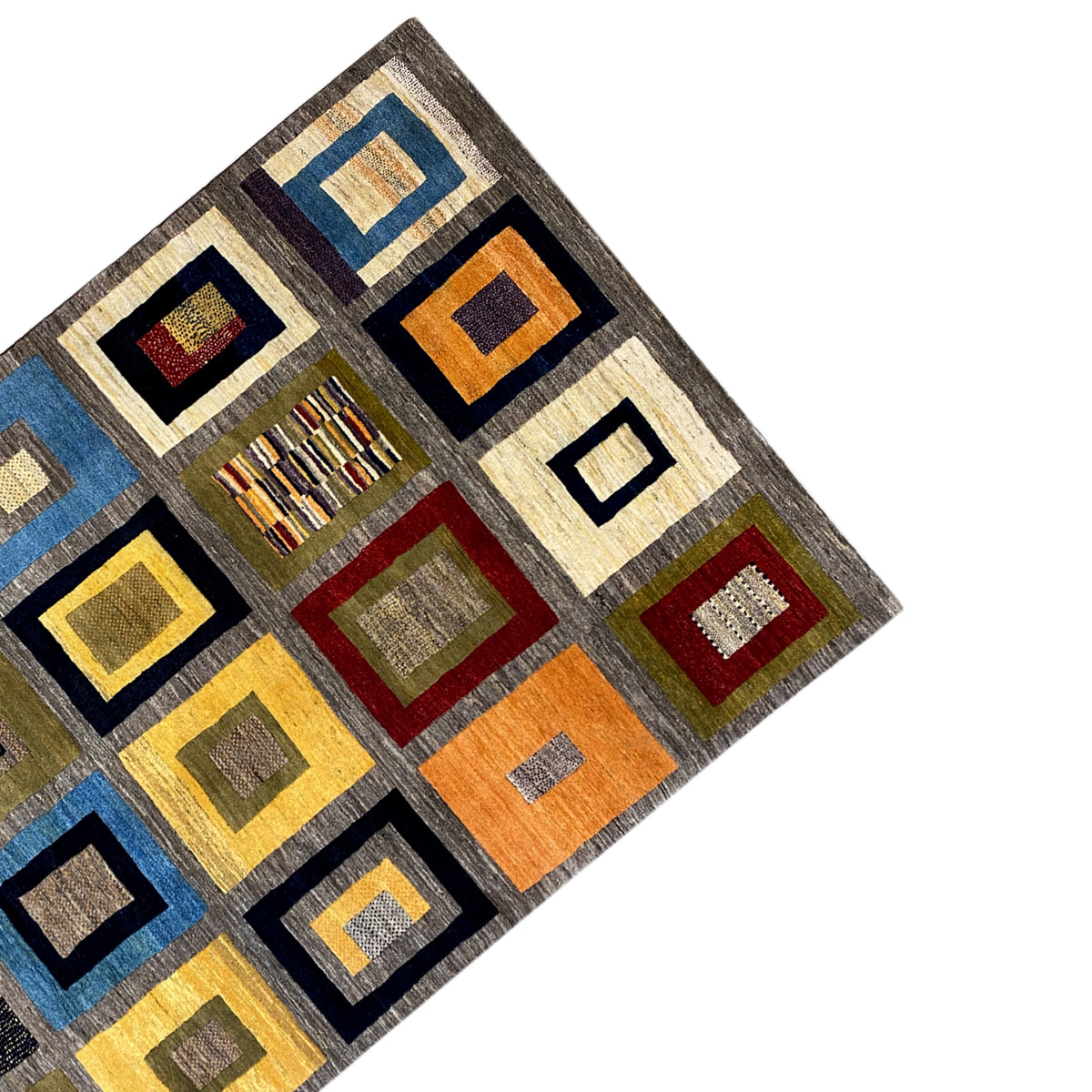 Corner of a Gabbeh rug with geometric squares in blue, yellow, red, and gray.