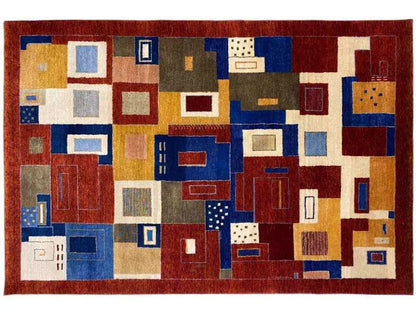 Oriental rug with a geometric patchwork pattern in red, blue, beige, and gold-colored sections