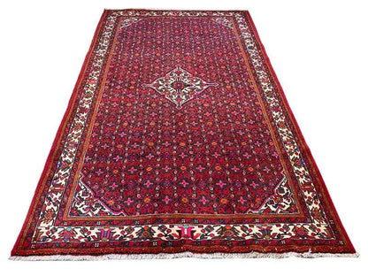 Hamedan oriental rug, large red medallion in dark red with decorative stripes
