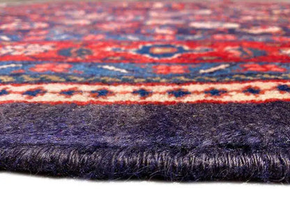 Rug edge with fringe, dark blue pile fabric and multicolored border
