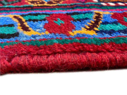 Rug edge with fringe, colorful woven texture on a dark blue base