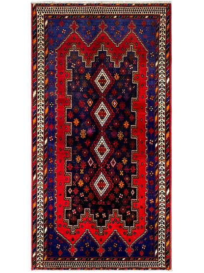 Rectangular runner rug with dark blue, a red ornamental center, and a beige border
