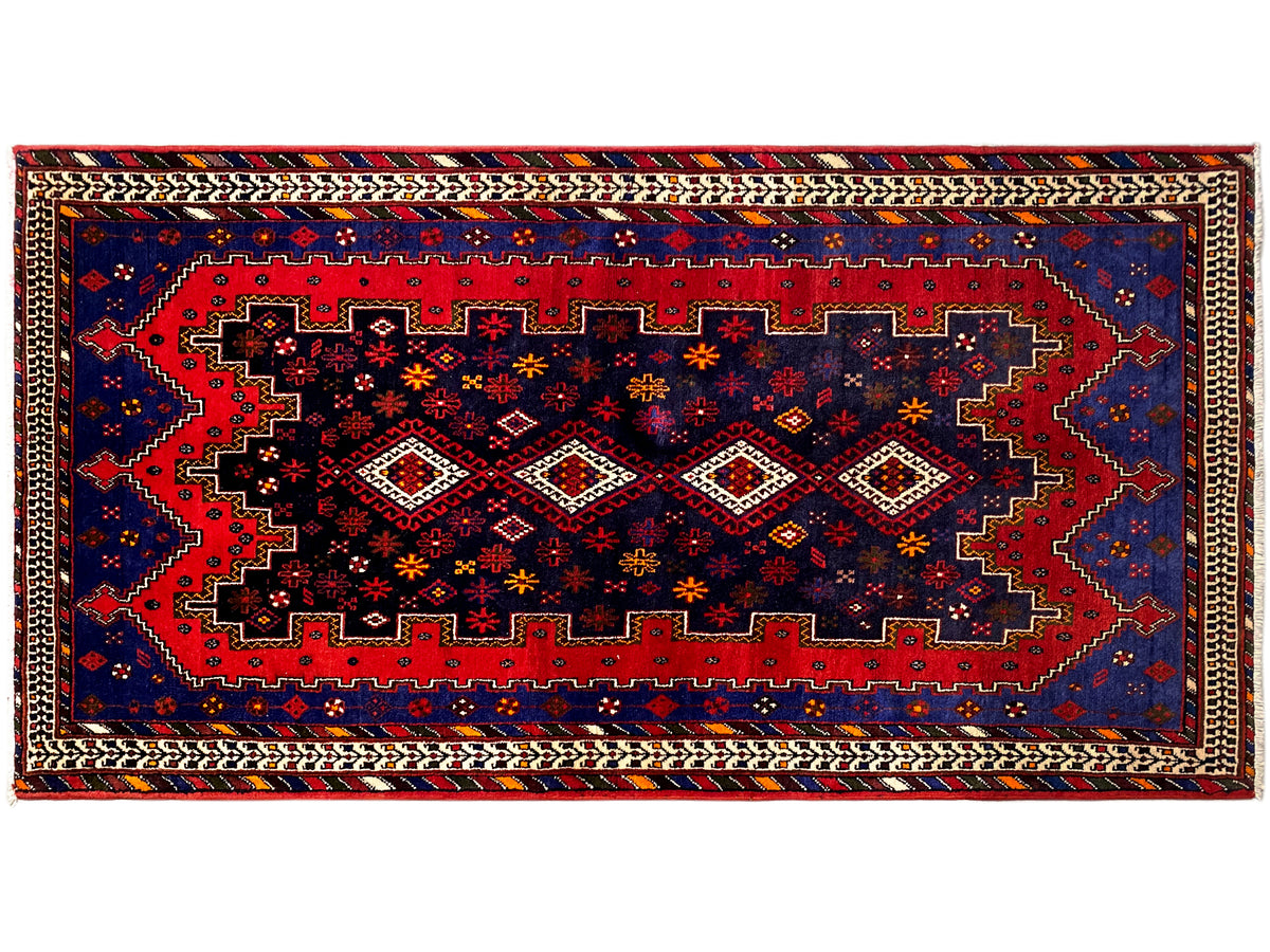 Runner rug with a wide geometric central band in blue, red, and beige outlines