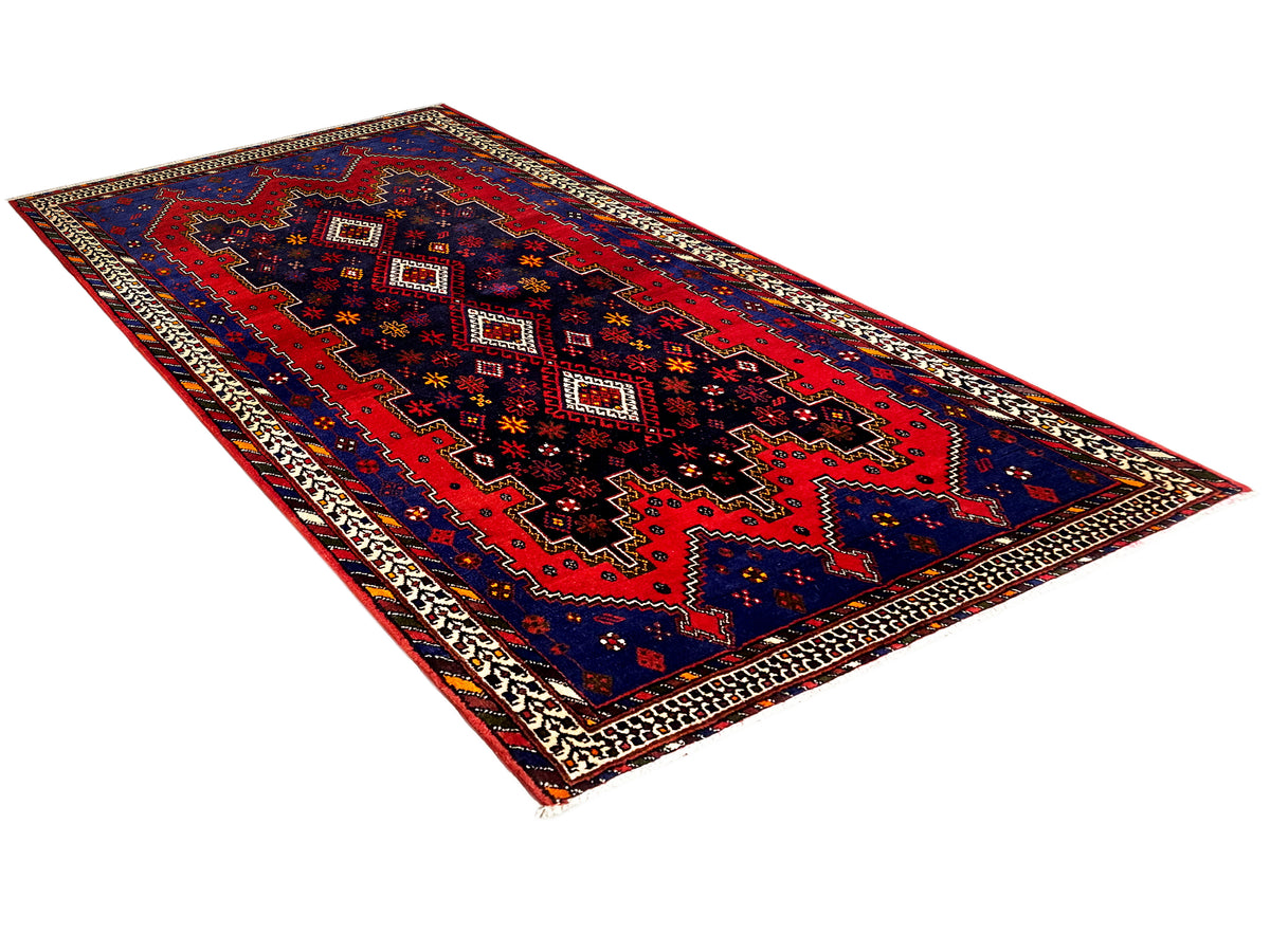 Sirjan runner rug with a geometric red-and-blue pattern and decorative border