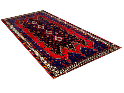 Sirjan runner rug with a geometric red-and-blue pattern and decorative border
