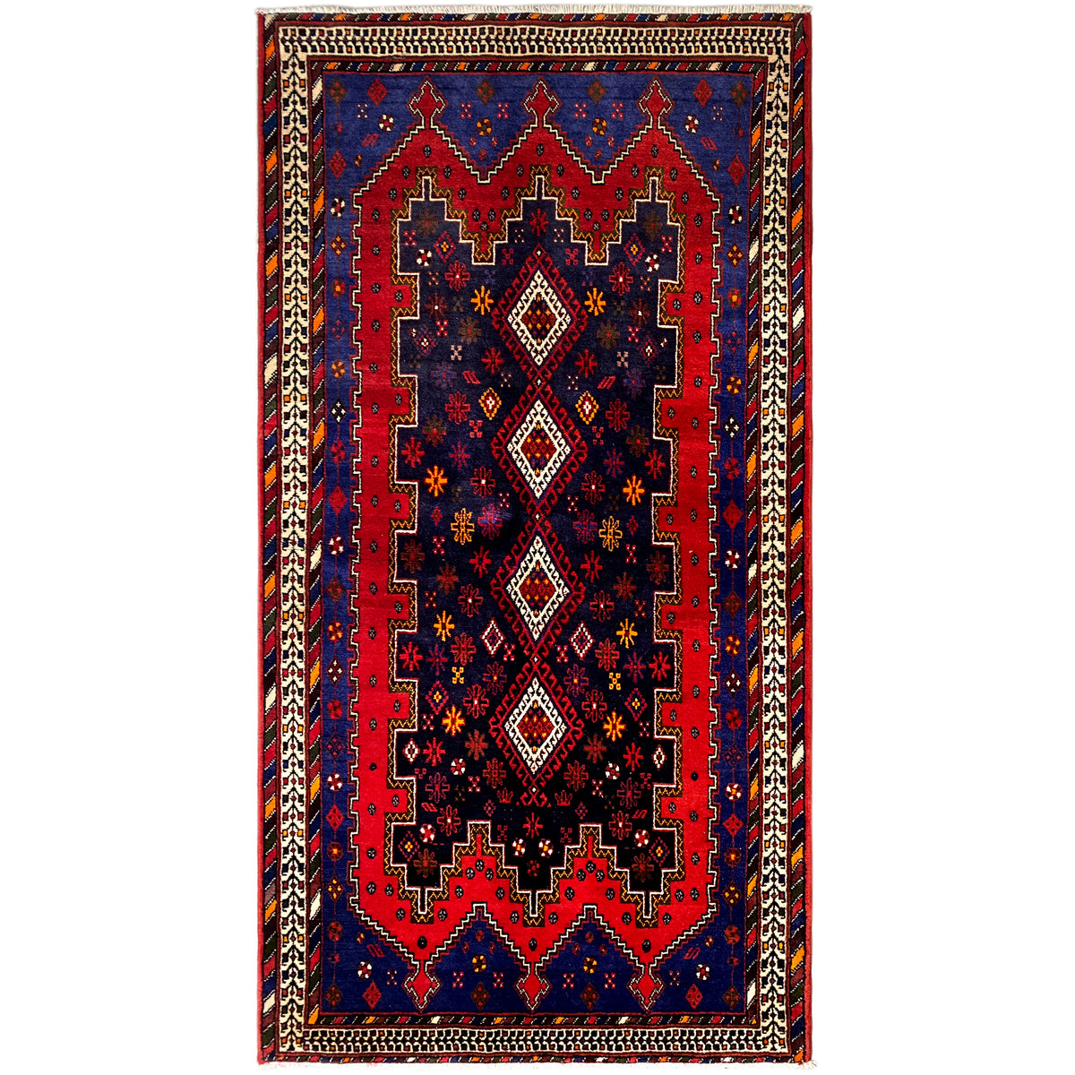 Rectangular runner rug with a blue-red pattern, beige border, and decorative trim