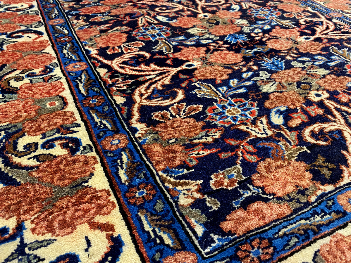 Close-up: blue border band with red and beige ornaments, densely woven pile