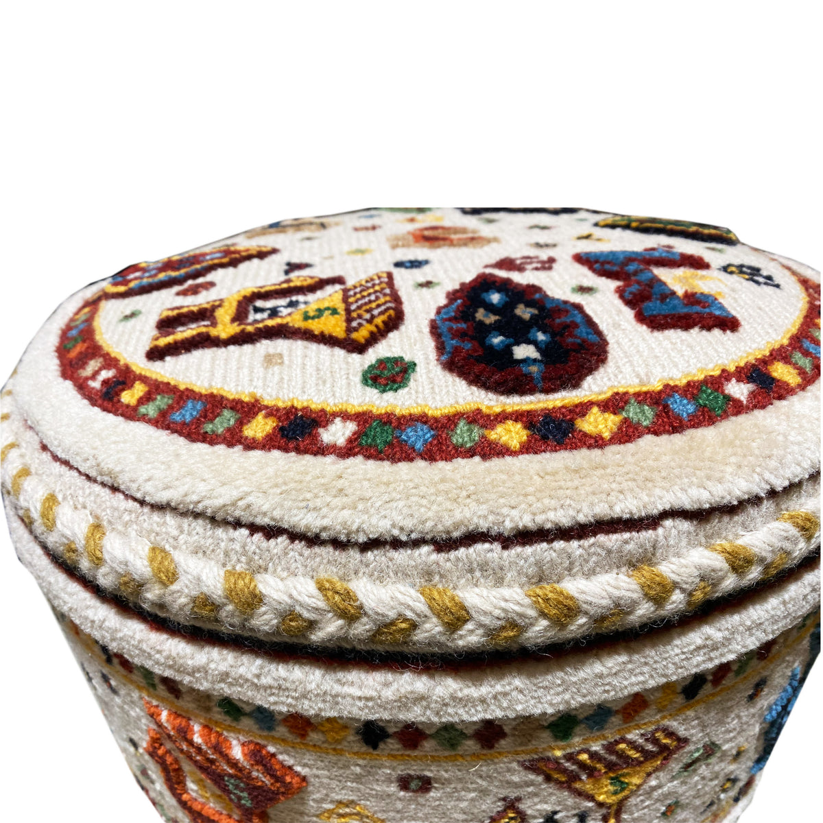 Stool lid with a circular ornament, colorful motifs, and braided decorative cord