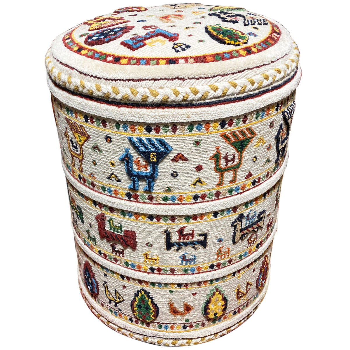 Round Soumak pouf with an embroidered pattern, cream-colored upholstery, and decorative trim