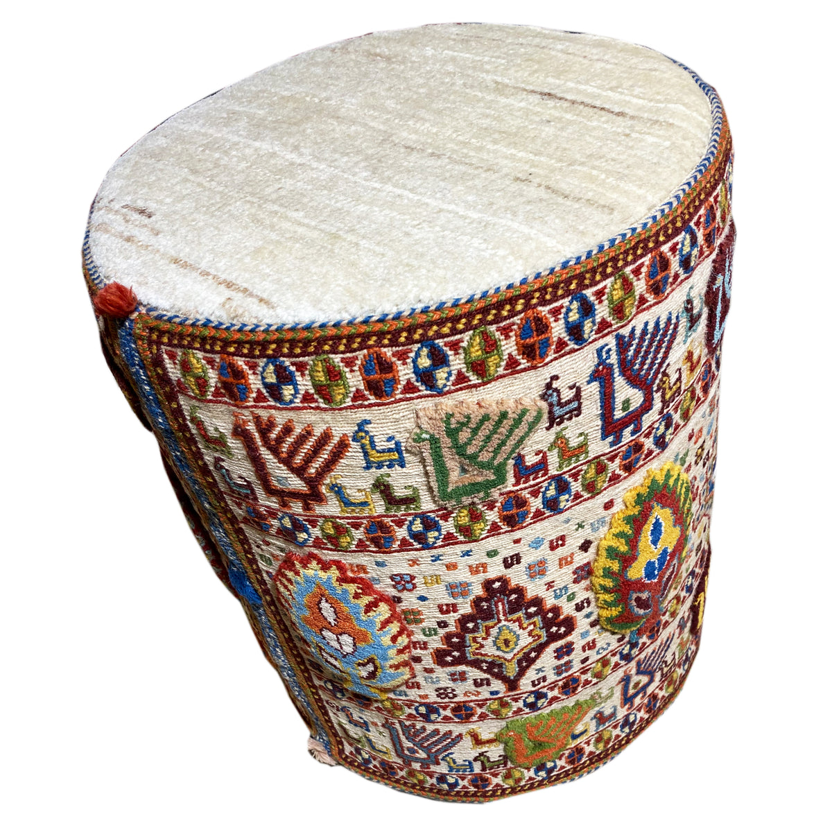 Round wool stool with a padded seat and decorative trim around the edge
