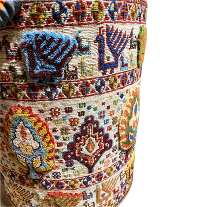 Close-up: wool stool cover with a blue motif and colorful carpet pattern