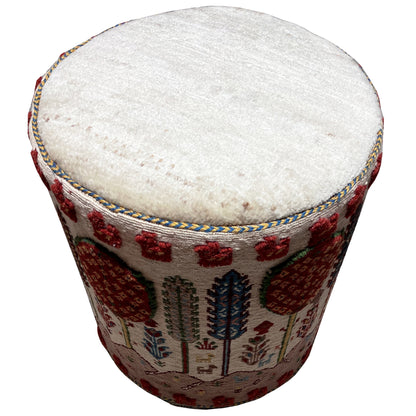 Colorful Soumak footstool with a round seat cushion and a multicolored decorative rug pattern