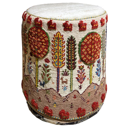Colorful Soumak stool with a round seat and multicolored pattern, side view