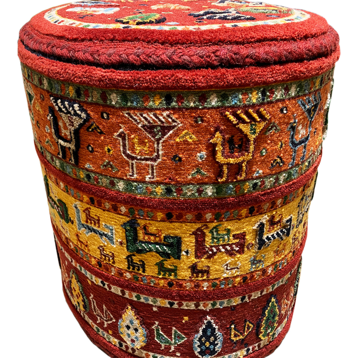Upholstered stool with a red seat and colorful Soumakh stripes, cylindrical shape