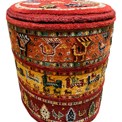 Upholstered stool with a red seat and colorful Soumakh stripes, cylindrical shape