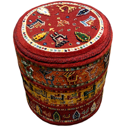 Round stool with a red Soumakh rug pattern, padded seat, and cylindrical sides