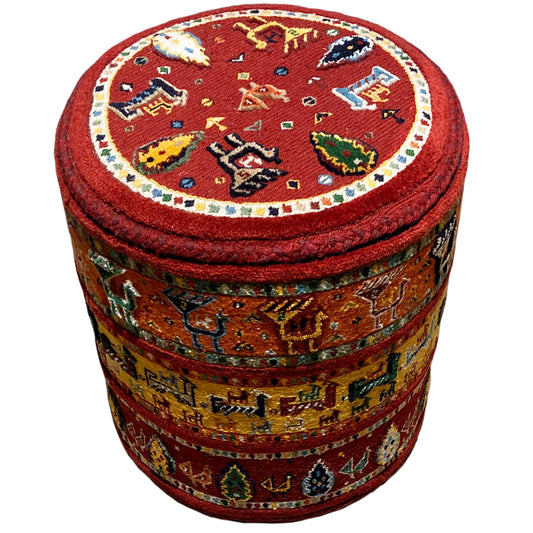 Round stool with a red Soumakh rug pattern, padded seat, and cylindrical sides
