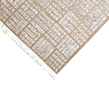 Corner area of the brown rug with a diagonal lattice pattern and white fringes
