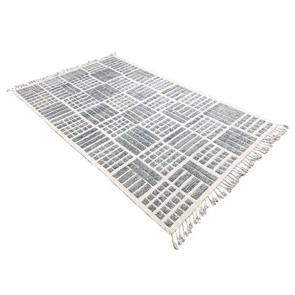 Rectangular gray-and-white wool rug with a geometric pattern and fringes