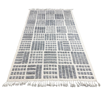 Gray rug with a dense geometric pattern of lines and bars, fringes around the edges