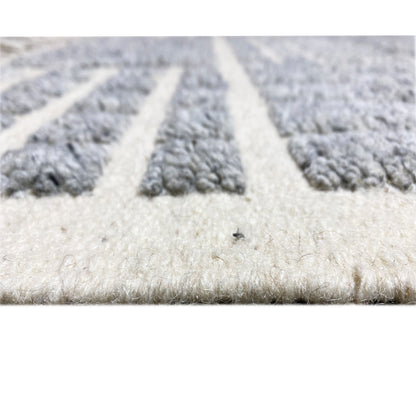 Close-up of the carpet pile: soft texture in light beige with gray sections