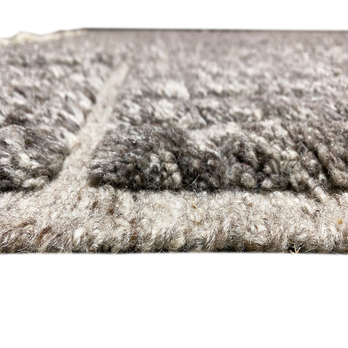 Close-up of pile and edge: dark and light mélange, textured surface