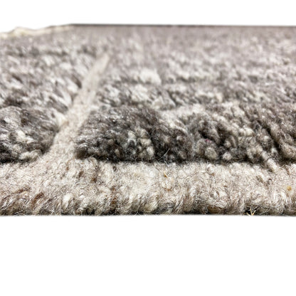 Close-up of pile and edge: dark and light mélange, textured surface