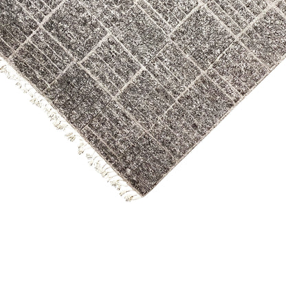 Corner in detail: dark check pattern, white fringes, mottled surface