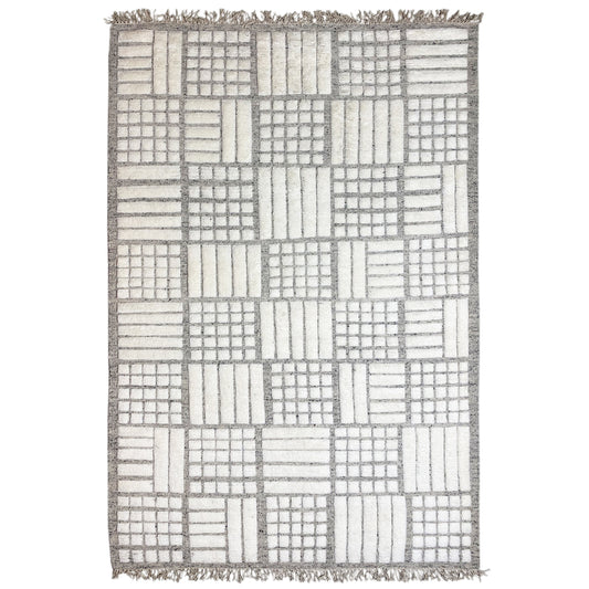 Berber rug with square patchwork in beige, gray, and white, with fringes