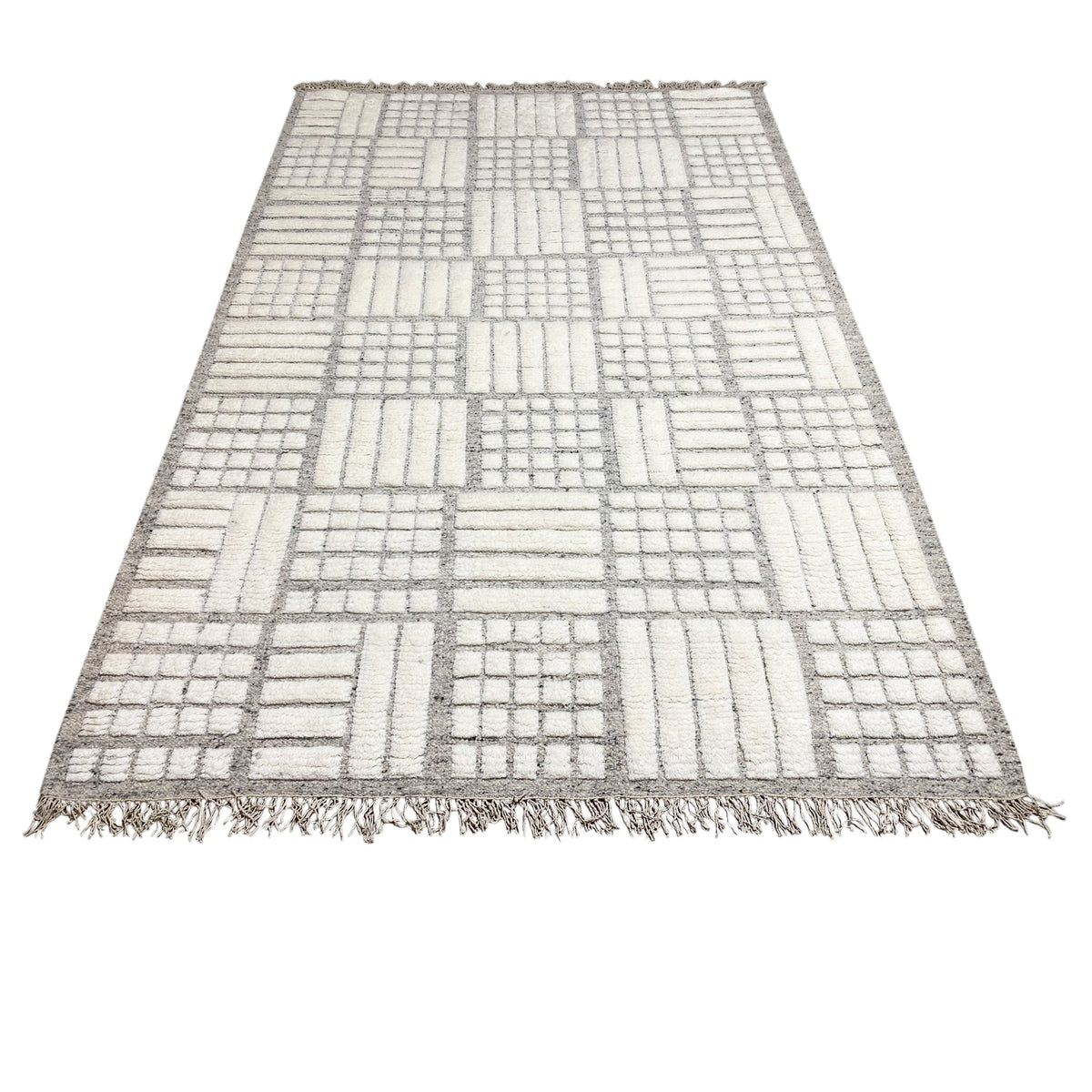 Berber rug with light gray and white patchwork design and fringes
