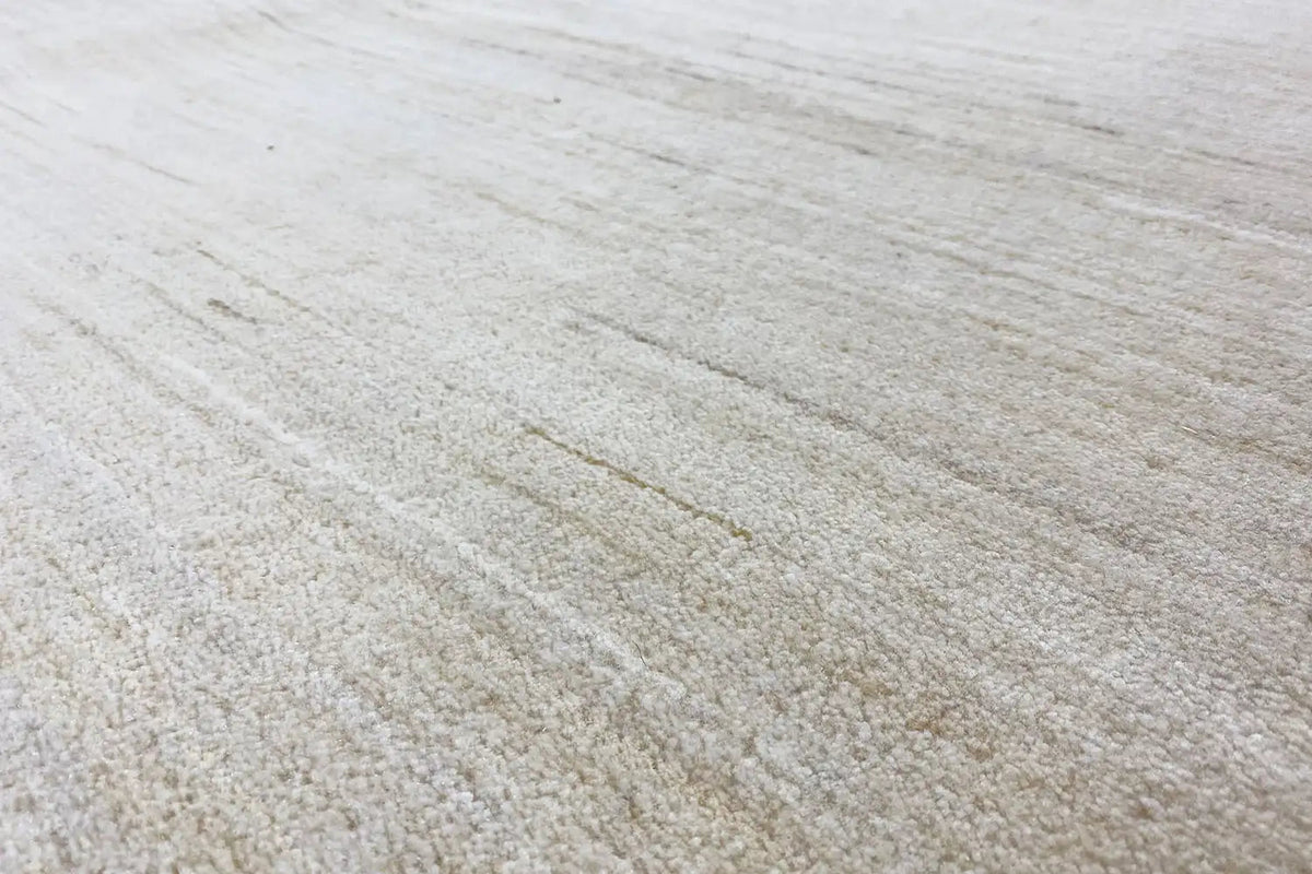 Light-colored rug with a fine, even pile and subtle lines