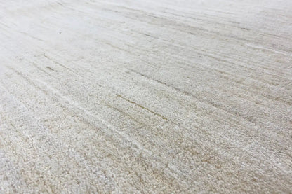 Light-colored rug with a fine, even pile and subtle lines
